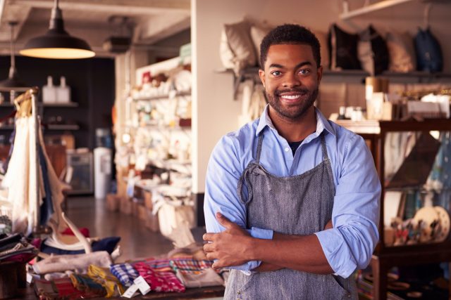 a man standing in a store with his arms crossed.